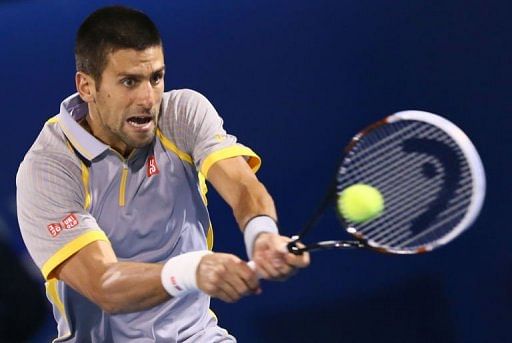 Novak Djokovic returns the ball at the Dubai Open February 27, 2013
