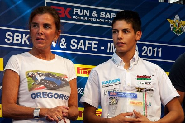 IMOLA, ITALY - SEPTEMBER 24:  Michael Ruben Rinaldi of Italy receives the premium from Chantal (mather of Gregorio) during the press conference &quot;SBK Fun &amp; Safe - Corri in pista e non in strada&quot; in Paddock Show before the  qualifying practice of Superbike World Championship Round Eleven at Autodromo Enzo e Dino Ferrari  on September 24, 2011 in Imola, Italy.
