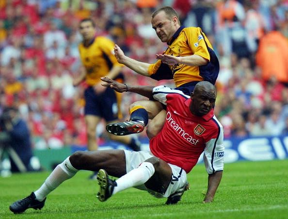 Arsenal&#039;s Patrick Vieira (bottom) is tackled by Li