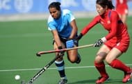 Ritu Rani (L) of India vies for the ball