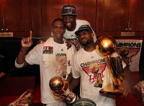MIAMI, FL - JUNE 21:  Chris Bosh #1, Dwyane Wade #3, and LeBron James #6 of the Miami Heat pose for a photo in the locker room after defeating the Oklahoma City Thunder during Game Five of the 2012 NBA Finals to win the NBA Championship at American Airlines Arena on June 21, 2012 in Miami, Florida. NOTE TO USER: User expressly acknowledges and agrees that, by downloading and or using this Photograph, user is consenting to the terms and conditions of the Getty Images License Agreement. Mandatory Copyright Notice: Copyright 2012 NBAE (Photo by Nathaniel S. Butler/NBAE via Getty Images)