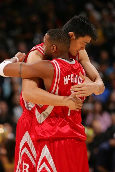 OAKLAND, CA - NOVEMBER 29: Tracy McGrady #1 and Yao Ming #11 of the Houston Rockets embrace before a game against the Golden State Warriors November 29, 2007 at Oracle Arena in Oakland, California. NOTE TO USER: User expressly acknowledges and agrees that, by downloading and or using this photograph, user is consenting to the terms and conditions of Getty Images License Agreement. Mandatory Copyright Notice: Copyright 2007 NBAE  (Photo by Rocky Widner/NBAE via Getty Images)