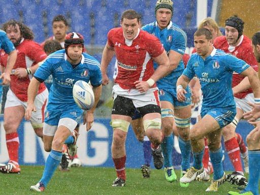 Ian Evans (C) of Wales vies with Kristopher Burton (L) of Italy during the Six Nations rugby, February 23, 2013  in Rome
