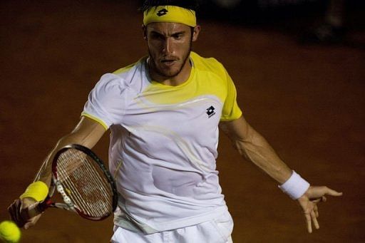 Leonardo Mayer of Argentina hits a return to Rafael Nadal of Spain in Acapulco, Guerrero state on February 28, 2013