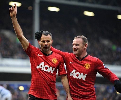 Ryan Giggs (left) celebrates with Wayne Rooney after scoring against QPR at Loftus Road on February 23, 2013