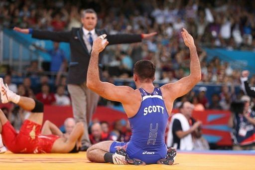American Coleman Scott (R) celebrates winning the Men&#039;s 60kg Freestyle bronze medal during the London 2012 Olympic Games