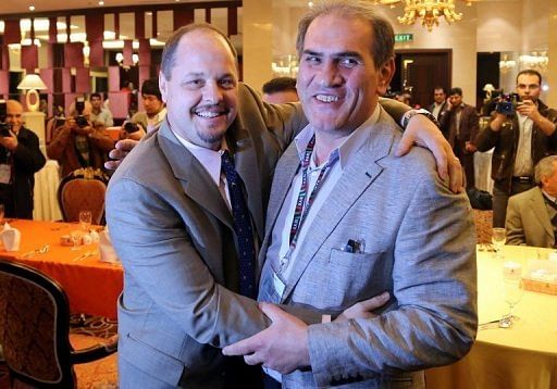 USA Wrestling&#039;s Rich Bender (L) poses with Iran&acirc;s wrestling federation head Hojatollah Khatib on February 20, 2013