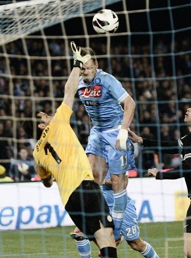 Juventus' goalkeeper Gianluigi Buffon (L) clashes with Napoli's Christian Maggio in Naples on March 1, 2013