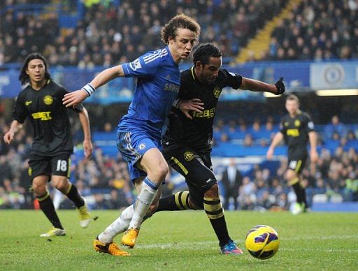 Chelsea&#039;s David Luiz (L) tries to run down  Wigan Athletic&#039;s  Jean Beausejour at Stamford Bridge on February 9, 2013