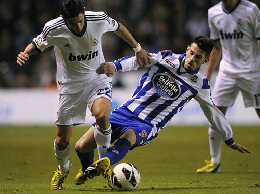 Real Madrid&#039;s Angel di Maria (L) is tackled by Deportivo&#039;s Pizzi during their Spanish league match on February 23, 2013