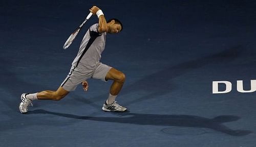 Serbia's Novak Djokovic returns the ball to Czech Republic's Tomas Berdych on March 2, 2013