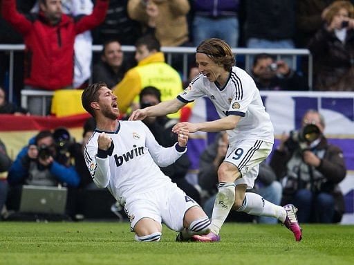 Real Madrid&#039;s defender Sergio Ramos (L) celebrates with midfielder Luka Modric after scoring in Madrid on March 2, 2013