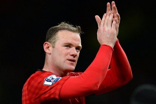 Manchester United&#039;s Wayne Rooney acknowledges the crowd at Old Trafford on February 10, 2013