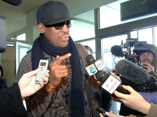 This photo taken on March 1, 2013 shows Dennis Rodman (C) being interviewed at Pyongyang Airport