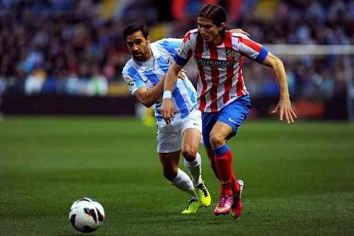 Malaga&#039;s Jesus Gamez (L) vies with Atletico Madrid&#039;s Filipe Luis on March 3, 2013 at the Rosaleda stadium in Malaga