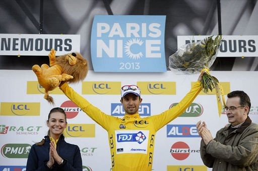 Nacer Bouhanni celebrates with his overall leader yellow jersey on the podium on March 4, 2013
