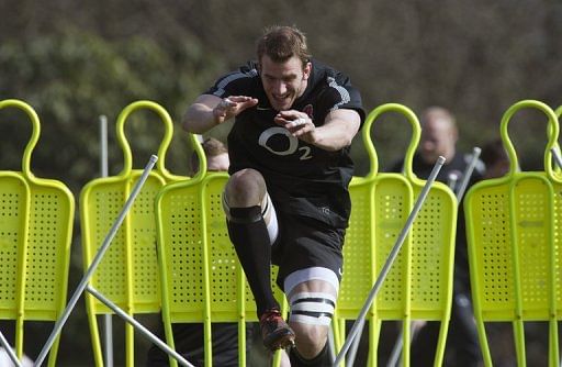 England&#039;s flanker Tom Croft jumps through obstacles during a training session in Bagshot on March 15, 2012