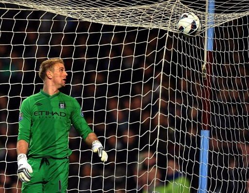 Manchester City goalkeeper Joe Hart eyes the ball over the net in Birmingham on March 4, 2013