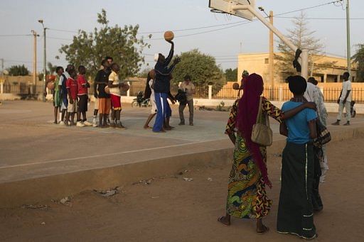 Youngsters play basketball at the former 