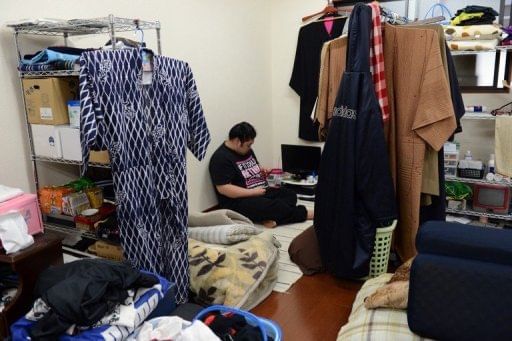 Sumo wrestler Genkaiho relaxes in his private space after training at a sumo stable in Tokyo on February 14, 2013