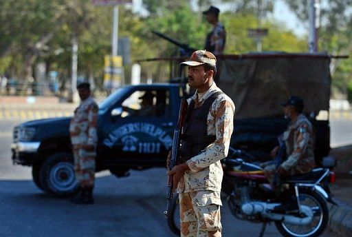 Pakistani paramilitary soldiers stand guard in Karachi on March 4, 2013, the day following a car bomb attack in the city