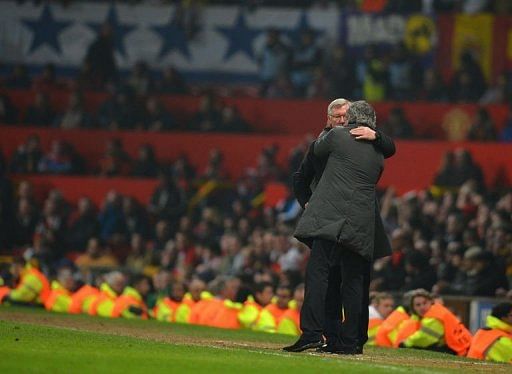 Alex Ferguson (L) and Jose Mourinho embrace towards the end of the UEFA Champions League match on March 5, 2013