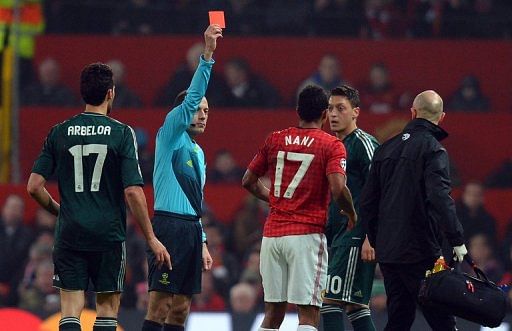 Cuneyt Cakir shows Nani the red card during the UEFA Champions League clash at Old Trafford on March 5, 2013