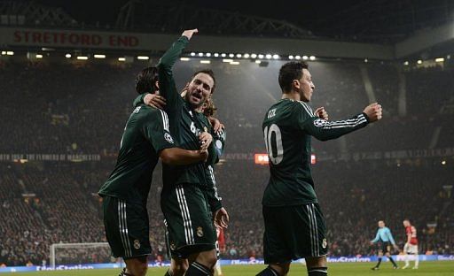 Real Madrid&#039;s Gonzalo Higuain (C) celebrates setting up his team&#039;s second goal at Old Trafford on March 5, 2013