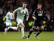 Celtic's Charlie Mulgrew (L) vies with Arturo Vidal of Juventus during the first leg at Celtic Park on February 12, 2013