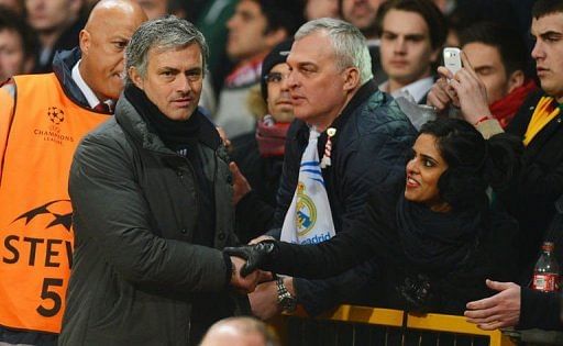 Real Madrid&#039;s manager Jose Mourinho (L) is greeted by fans as he leaves the pitch at Old Trafford on March 5, 2013