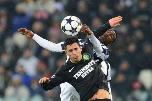 Celtic&#039;s Beram Kayal fights for the ball with Juventus&#039; Kwadwo Asamoah (back) on March 6, 2013 in Turin
