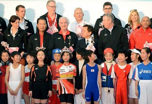 International Olympic Committee (IOC) members pose with children in Tokyo on March 6, 2013
