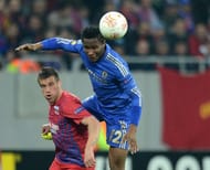 John Obi Mikel (R) of Chelsea fights for the ball with Mihai Doru Pintilii (L) of Steaua Bucharest on March 7, 2013