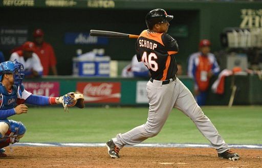 Netherlands&#039; Jonathan Schoop bats as Cuba&#039;s catcher Frank Morejon looks on at Tokyo Dome on March 8, 2013