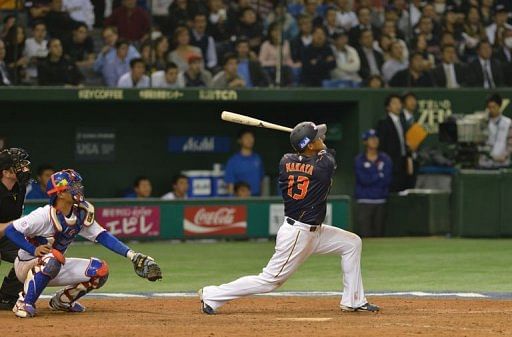 Japan&#039;s outfielder Sho Nakata (R) bats a timely sacrifice fly against Taiwan on March 8, 2013