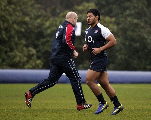 England&#039;s prop Dan Cole (L) and England&#039;s centre Manu Tuilagi (R) warm up at the team&#039;s training base, March 8, 2013