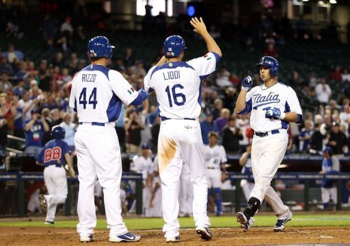 Chris Colabello (R) hit a three-run home run against Canada in the World Baseball Classic on March 8, 2013.