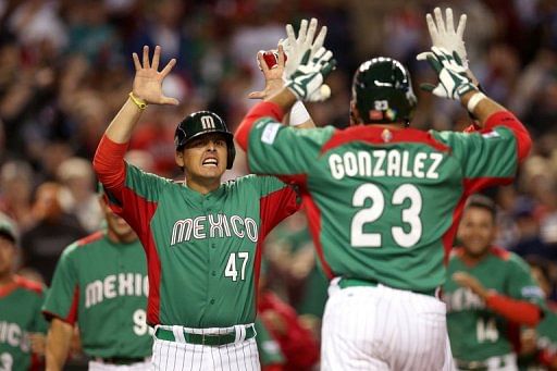 Mexico&#039;s Luis Cruz (L) congratulates teammate Adrian Gonzalez, at Chase Field in Phoenix, Arizona, on March 8, 2013