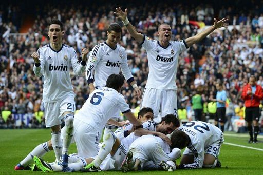 Real Madrid players celebrate their second goal against Barcelona in Madrid on March 2, 2013