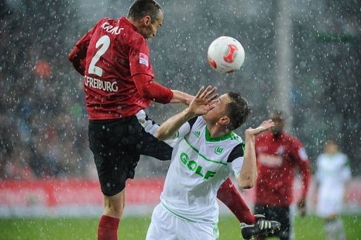 Freiburg&#039;s defender Pavel Krmas (L) and Wolfsburg&#039;s striker Ivica Olic fight for the ball in Freiburg, March 9, 2013