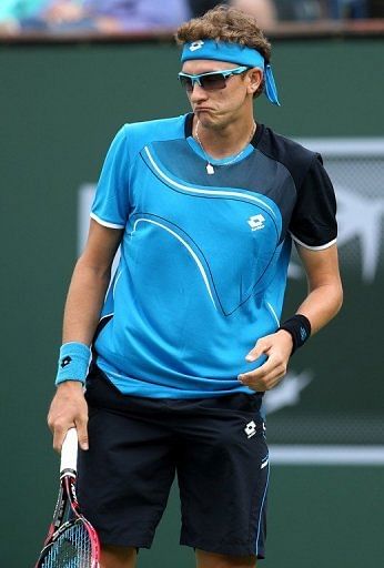 Denis Istomin reacts to a shot from Roger Federer at the BNP Paribas Open at Indian Wells on March 9, 2013