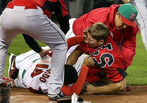Eduardo Arredondo (L) of Mexico fights with Jay Johnson of Canada during the World Baseball Classic on March 9, 2013