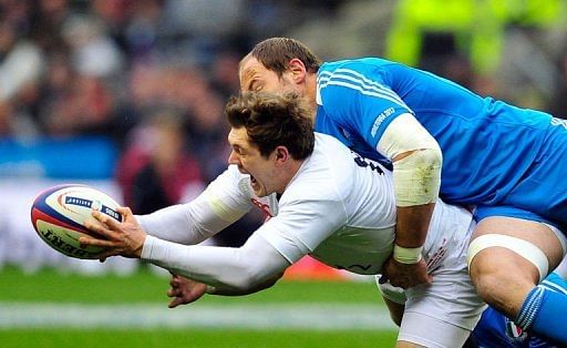 England&#039;s Alex Goode (L) is tackled by Italy&#039;s Sergio Parisse at Twickenham on March 10, 2013