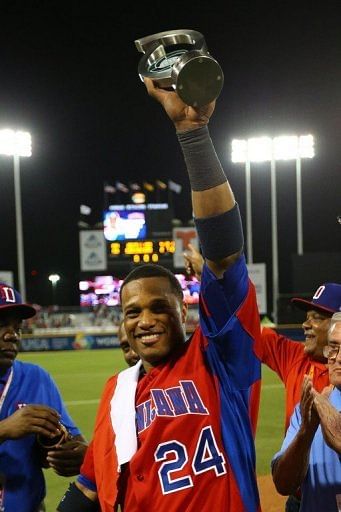 Robinson Cano of the Dominican Republic holds the MVP trophy after defeating Puerto Rico at the WBC on March 10, 2013