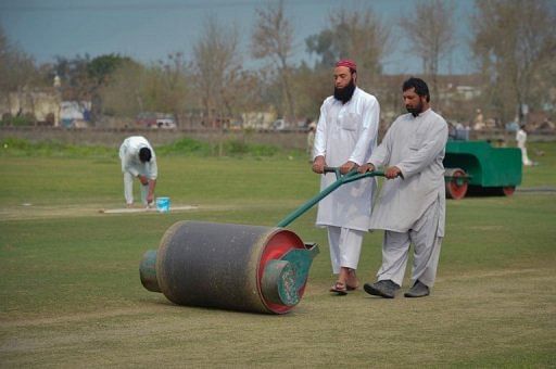 Ground staff prepare a pitch in northwest Swabi, the hometown of a Pakistani cricketer Fawad Ahmed on March 9, 2013.
