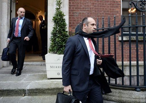 France&#039;s Philippe Saint Andre (R) and assistant coach Yannick Bru (L) leave their hotel in Dublin on March 10, 2013