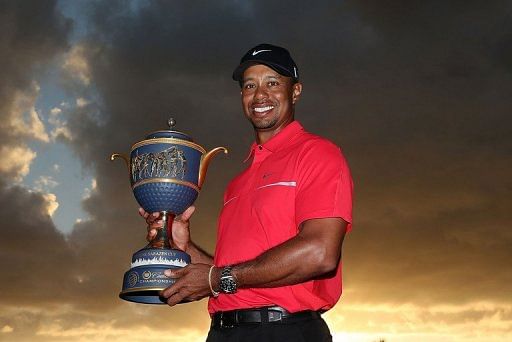 Tiger Woods poses with the Gene Sarazen Cup at the Trump Doral Golf Resort &amp; Spa on March 10, 2013 in Doral