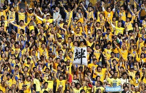 Supporters of Vegalta Sendai cheer at Yurtec Stadium in Sendai, Miyagi prefecture on April 29, 2011