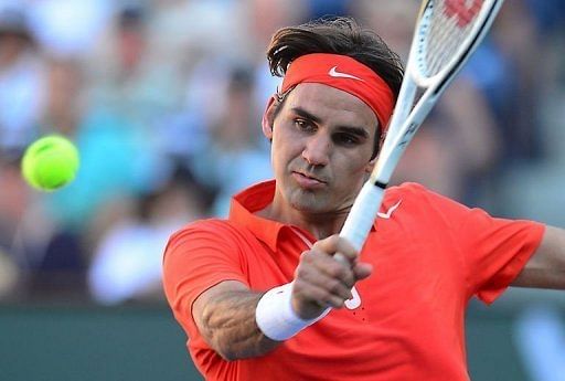 Roger Federer returns against Ivan Dodig at Indian Wells on March 11, 2013