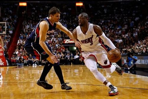 Dwyane Wade of the Miami Heat drives against Kyle Korver of the Atlanta Hawks on March 12, 2013